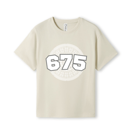 A light beige short-sleeve t-shirt with a large graphic on the chest featuring the numbers '675' in white with a grey outline
