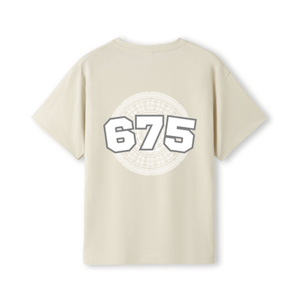 A cream-colored short-sleeve t-shirt with a large graphic on the back featuring the number '675' in white with a grey outline