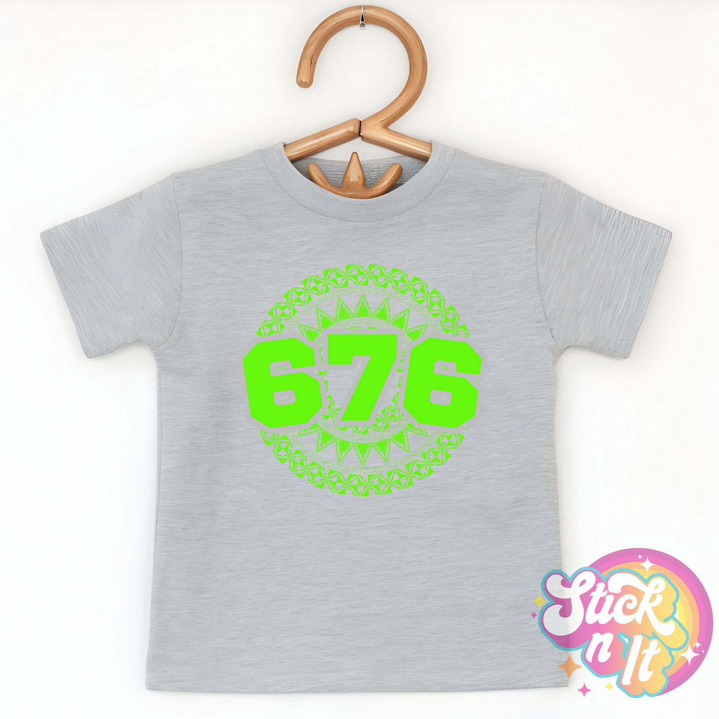 Kids size grey shirt featuring a Polynesian Tonga design with area code 676 in lime.