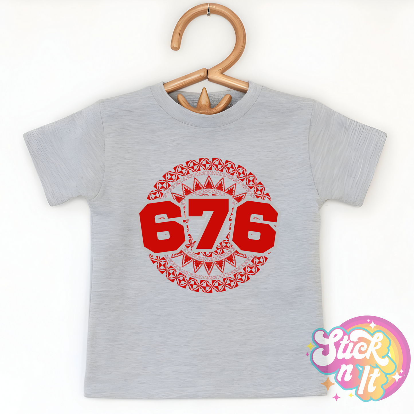 Kids size grey shirt featuring a Polynesian Tonga design with area code 676 in red.