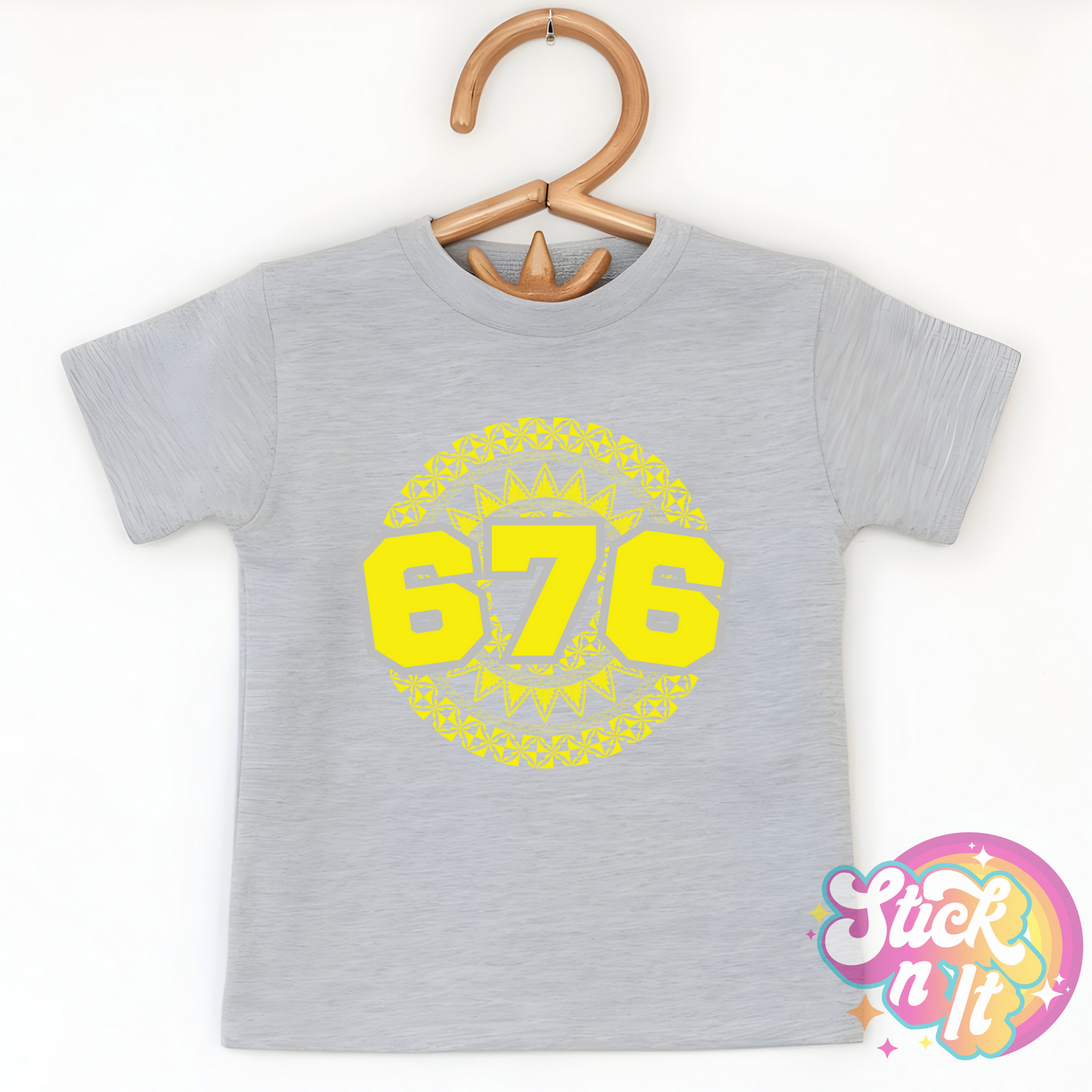 Kids size grey shirt featuring a Polynesian Tonga design with area code 676 in yellow.