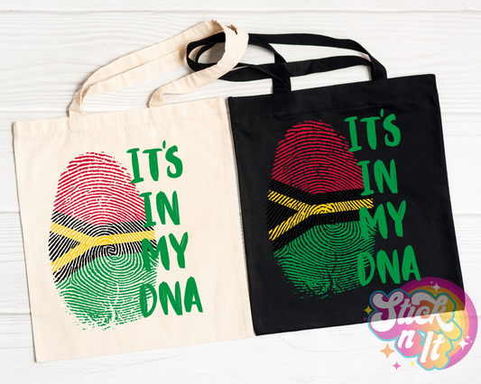 Black and natural colour tote bags featuring quote It's in my DNA in green with a fingerprint shaped Vanuatu flag